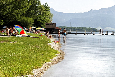 People enjoying summer on the foreshore of lake Chiemsee, Chiemgau, Upper Bavaria, Germany, Europe