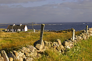 Cottage on coastal landscape, Cleggan, Connemara, Republic of Ireland, Europe