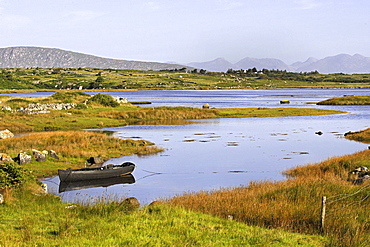 Lake landscape with Maumturk Mountains at sunrise, Connemara, Republic of Ireland, Europe