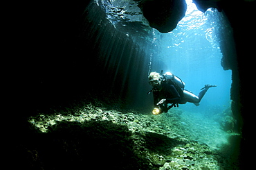 Scuba diver exploring an underwater cave, Musandam, Oman, Arabian Peninsula, Middle East, Indian Ocean