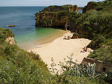 Typical steep coast, cliffs, and Praia dos Estudantes beach near Lagos, Algarve, Portugal, Europe