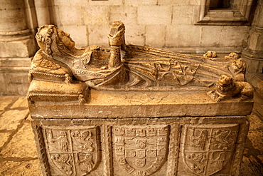 Woman with book on a tombstone in the cathedral Santa Maria Maior de Lisboa or Lisbon Cathedral, Lisbon, Portugal, Europe