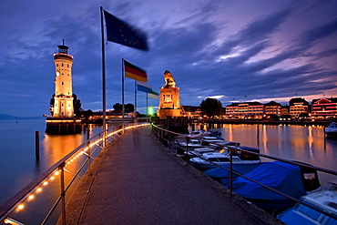 Lindau port entrance in the evening light shortly after sunset, lighthouse and the Bavarian lion sculpture, Lake Constance, Bavaria, Germany, Europe