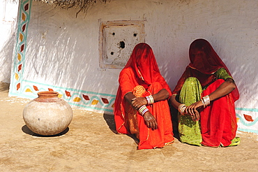 Veiled women talking in front of their house, Thar Desert, Rajasthan, North India, India, Asia