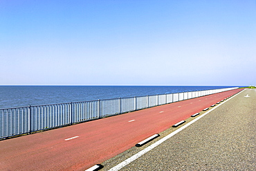 Highway with red asphalt along the sea, Holland, Netherlands, Europe