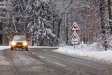 Sign, curves, danger of skidding, car on a road in winter, Baden-Wuerttemberg, Germany, Europe