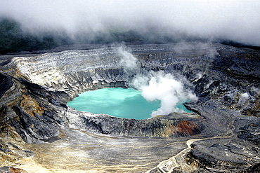 Poas Volcano, national park in the central highlands of the Alajuela Province, main crater with blue water, sulphur vapour, smoke and clouds, Parque Nacional Volcan Poas, Costa Rica, Central America