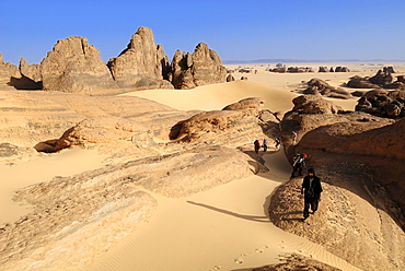 Group of tourists, hikers in the sandstone rock formation of Tin Akachaker, Tassili du Hoggar, Wilaya Tamanrasset, Algeria, Sahara desert, North Africa