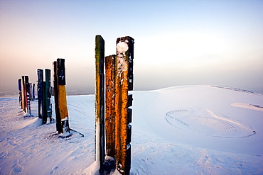 "Totems" landmark art installation created from more than 100 processed railway sleepers by Basque painter and sculptor Agustin Ibarrola, situated on snow-covered mining waste heap Halde Haniel above the pit Prosper-Haniel in winter, Bottrop, North Rhine-