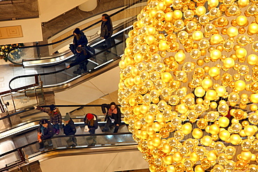 Christmas decorations, many small golden Christmas baubles make up one large Christmas bauble hanging in the staircase of a shopping centre, Essen, North Rhine-Westphalia, Germany, Europe