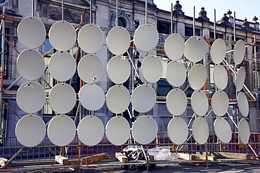Many TV satellite dishes on a frame