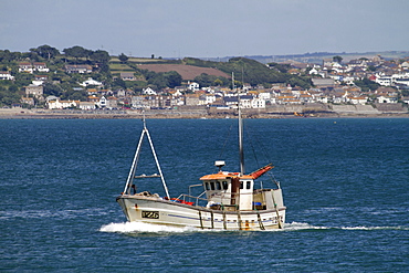 Fishing boat passing through the port of Newlyn, Cornwall, England, United Kingdom, Europe