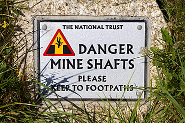 Sign warning of the danger of former mine shafts at Cape Cornwall, Cornwall, England, United Kingdom, Europe