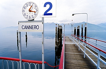 Pier with departure time clock, Cannero Riviera, Lake Maggiore, Piedmont, Italy, Europe