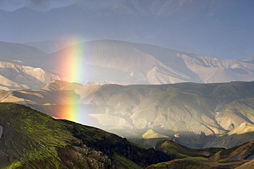 Segment of a rainbow over the rhyolite mountains near the Landmannalaugar region, Hrafntinnusker mountain, Laugavegur hiking trail, Fjallabak Nature Reserve, Highlands of Iceland, Europe