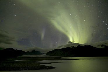 Polar lights (Aurora borealis), over Skaftafellsa river and Skaftafellsjoekull glacier, Skaftafell, Vatnajoekull National Park, southern Iceland, Europe