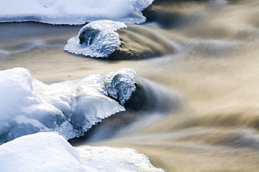 Flowing mountain stream in winter, South Tyrol, Italy, Europe