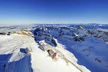 Snow-covered Alpstein massif and some mountain inns as seen from the summit of Saentis mountain, canton of Appenzell Innerrhoden, Switzerland, Europe