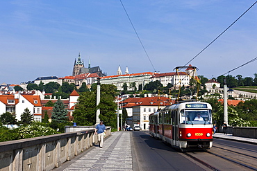 View of a bridge across the Vltava River, Prague Castle at the back, St. Vitus Cathedral, Hradcany district, Prague, Bohemia region, Czech Republic, Europe