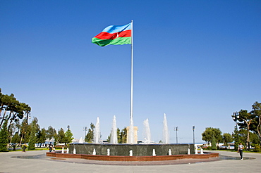 Azerbaijani flag in the wind in a park on the waterfront, Baku, Azerbaijan, Middle East