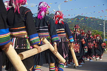 Women of the Akha ethnic minority from the province of Phongsali in Laos marching in colourful costumes with bamboo tubes at a festival, Jiangcheng, Pu'er City, Yunnan Province, People's Republic of China, Southeast Asia, Asia