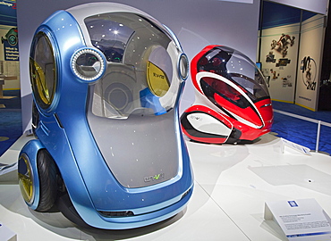 General Motors EN-V concept vehicles; the pod-like two-passenger electric cars may someday be produced for short-range urban transportation; the blue vehicle is called Xiao, "laugh", and the red one is called Jiao, "pride", on display at the North America