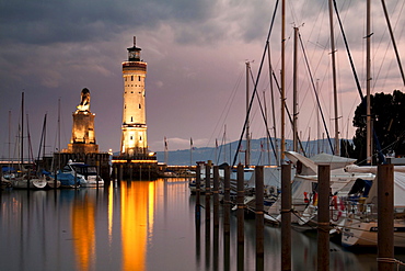 Lighthouse and the Bavarian lion, symbol of the city, at the harbour entrance of Lindau on Lake Constance, Bavaria, Germany, Europe