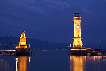 Lighthouse and the Bavarian lion, symbol of the city, at the harbour entrance of Lindau on Lake Constance, Bavaria, Germany, Europe