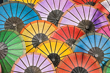 Multicoloured hand made paper umbrellas or parasols on sale at the handicraft evening market in Luang Prabang, Laos, Southeast Asia