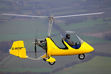 Aerial view, yellow gyrocopter, helicopter over the Muensterland area, North Rhine-Westphalia, Germany, Europe