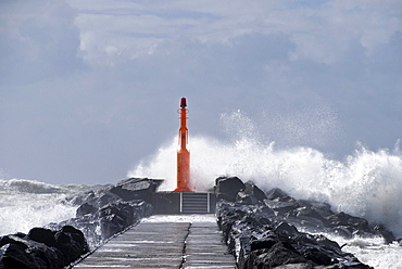 Strong waves with spray in a storm at the pier of Hvide Sande, Jutland, Denmark, Europe