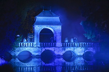 Blue floodlit bridge at the "Illumina" at Schloss Dyck, Juechen, Neuss, North Rhine-Westphalia, Germany, Europe