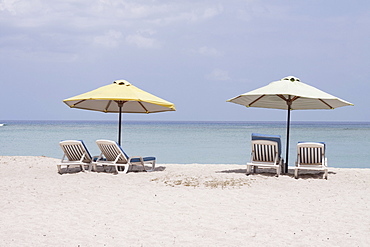 Sunloungers and beach umbrellas on the public beach of Flic en Flac, Mauritius, Africa