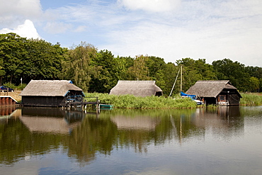 Boat houses on the Prerower Strom estuary, Fischland-Darss-Zingst peninsula, Mecklenburg-Western Pomerania, Germany, Europe