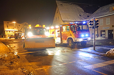 Winter services scattering salt on the road, ice hazard through water used for for firefighting, Kirchheim unter Teck, Baden-Wuerttemberg, Germany, Europe