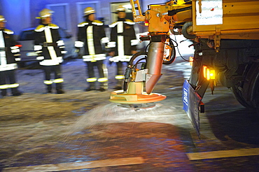 Winter services scattering salt on the road, ice hazard through water used for for firefighting, Kirchheim unter Teck, Baden-Wuerttemberg, Germany, Europe