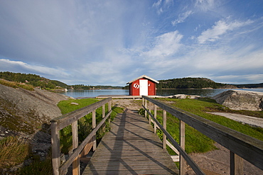 Boardwalk and red wooden hut on Badplats, Henan, Vaestragoetaland laen, Sweden, Europe