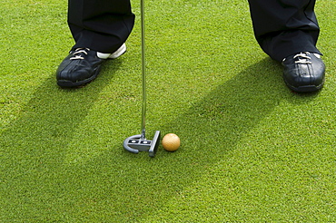 Golfer putting on the green