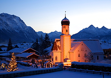 Snow-covered church with Christmas lighting near Wallgau, Upper Bavaria, Bavaria, Germany, Europe