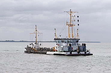 Ship for the removal of silt and sand from the harbour bed, in front of Norddeich in the Wadden Sea, Lower Saxony, Germany, Europe