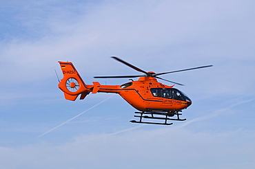 Orange helicopter of the air rescue in flight, rescue helicopter Christoph 3