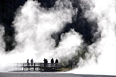 Tourists on a boardwalk amidst the steam of the springs and geysers, Black Sand Basin, Upper Geyser Basin, Yellowstone National Park, Wyoming, United States of America, USA