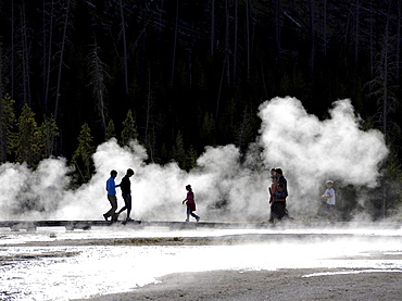 Tourists on a boardwalk amidst the steam of the springs and geysers, Black Sand Basin, Upper Geyser Basin, Yellowstone National Park, Wyoming, United States of America, USA