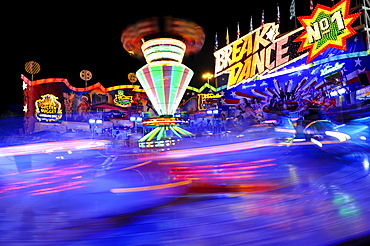 Breakdance ride at night, carousel, motion blur, Cannstatter Wasen or Volksfest, Stuttgart Beer Festival, Wasen, Bad Cannstatt, Stuttgart, Baden-Wuerttemberg, Germany, Europe