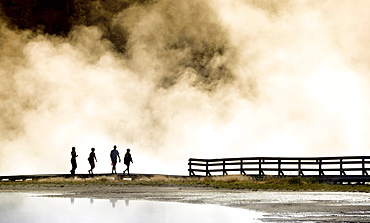 Tourists on boardwalk, steaming geothermal springs, geysers, Midway Geyser Basin, Yellowstone National Park, Wyoming, United States of America, USA