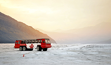 Brewster special bus, Ice Explorer Snowcoach, snowmobile for tourists to explore the glacier, at dusk, Athabasca Glacier, Columbia Icefield, Icefields Parkway, Jasper National Park, Canadian Rockies, Rocky Mountains, Alberta, Canada