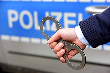 Police, police car, police officer with handcuffs