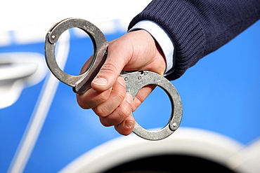 Police, police car, police officer with handcuffs