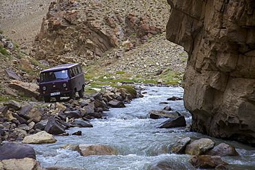 UAZ off-road vehicle bus at a creek in the Pamir mountain range, Tajikistan, Central Asia