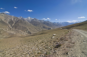 Dirt road leading through mountainous landscape, Wakhan Valley, Pamir Mountains, Tajikistan, Central Asia